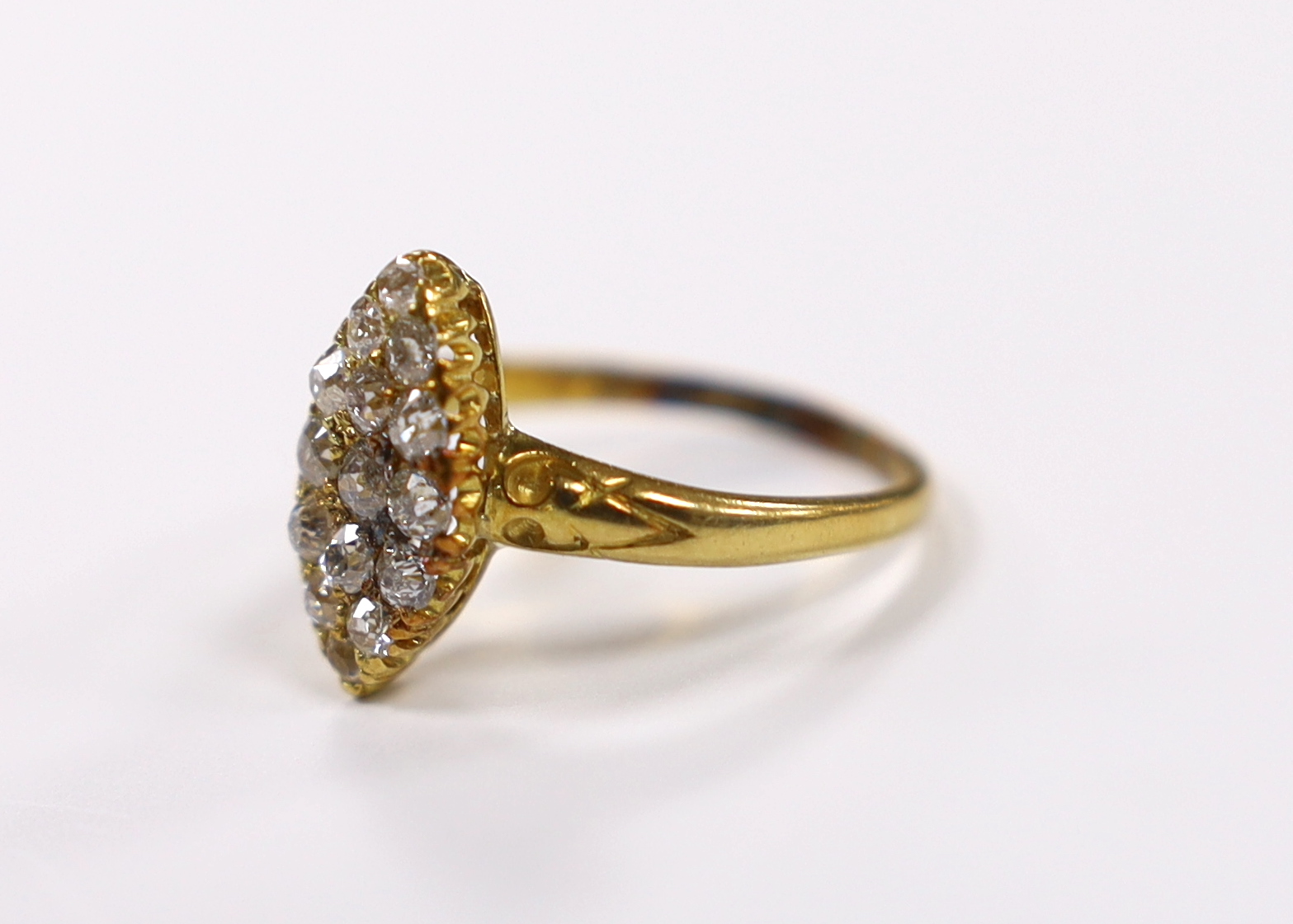 An early 20th century yellow metal and old round cut diamond cluster set marquise shaped ring, size O, gross weight 3.3 grams.